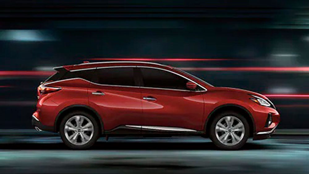 2023 Nissan Murano shown in profile driving down a street at night illustrating performance. | King Windward Nissan in Kaneohe HI